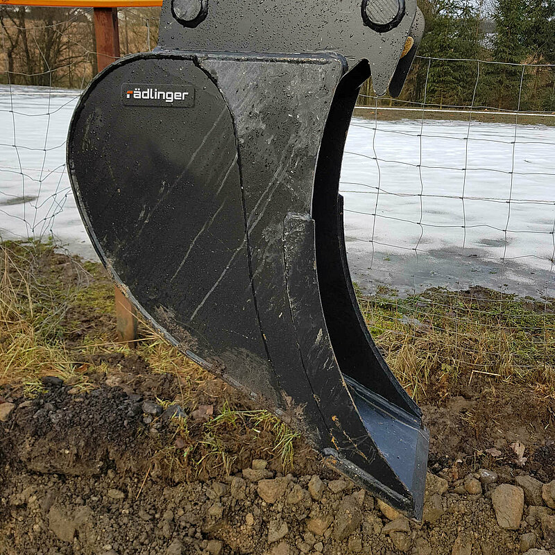 Close-up of a Standard Backhoe Bucket without Teeth (up to 6 t) by Rädlinger, in an empty state